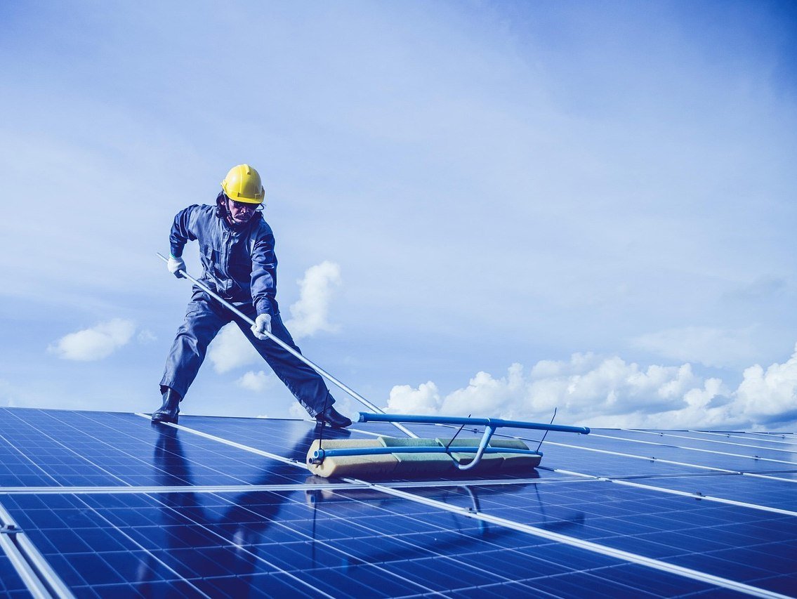 Technician servicing solar panels